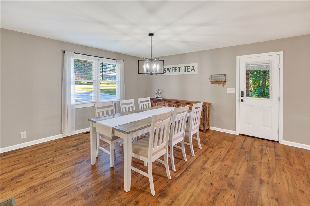 207 Ridgecrest Drive Williamston, SC 29697 - Photo 4 of 22 Rich wood flooring runs throughout this inviting dining room featuring direct backyard access.