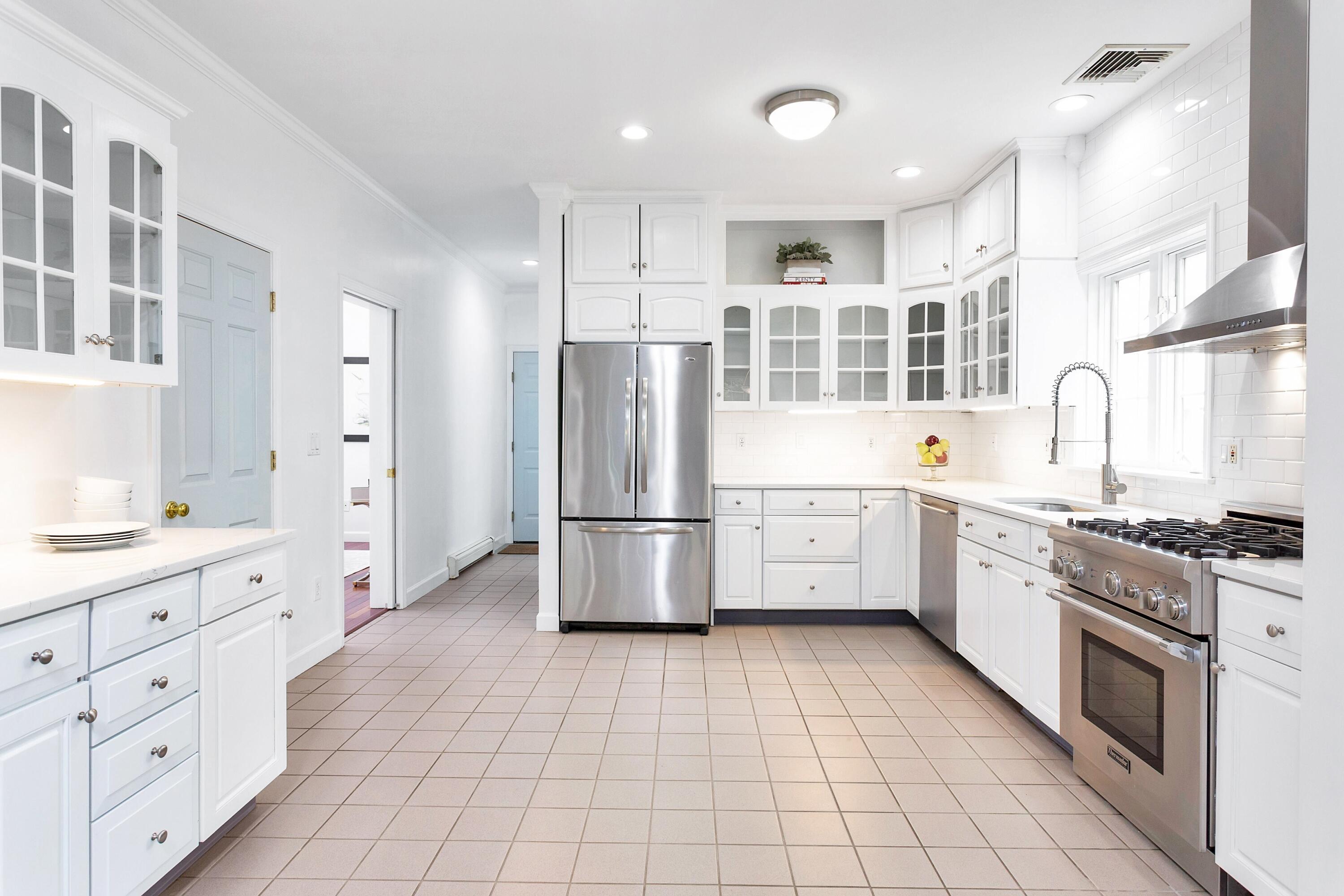 28 Dickinson Road Darien, CT 06820 - Photo 15 of 42 a kitchen with stainless steel appliances a refrigerator sink and cabinets