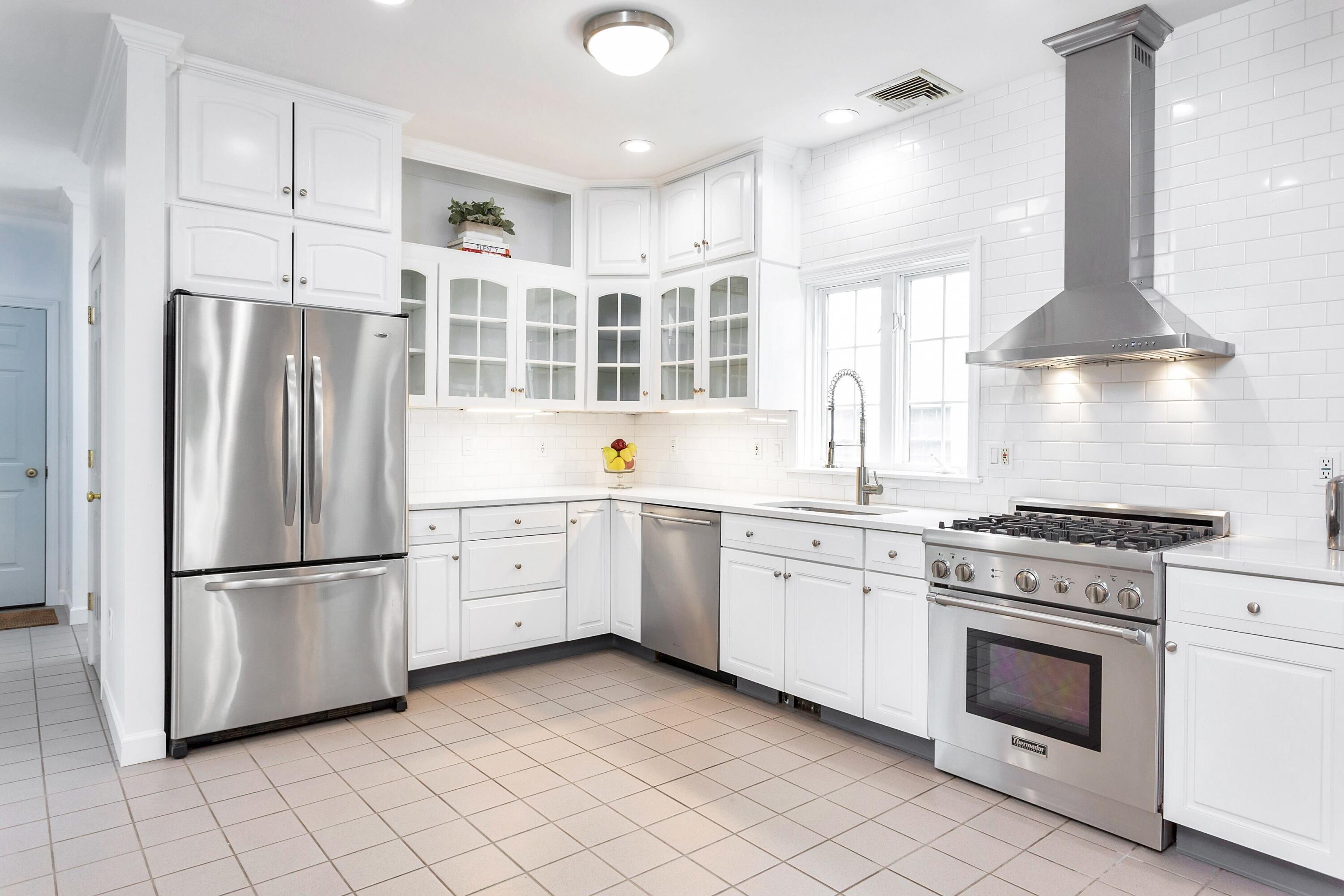 28 Dickinson Road Darien, CT 06820 - Photo 16 of 42 a kitchen with cabinets stainless steel appliances and a sink