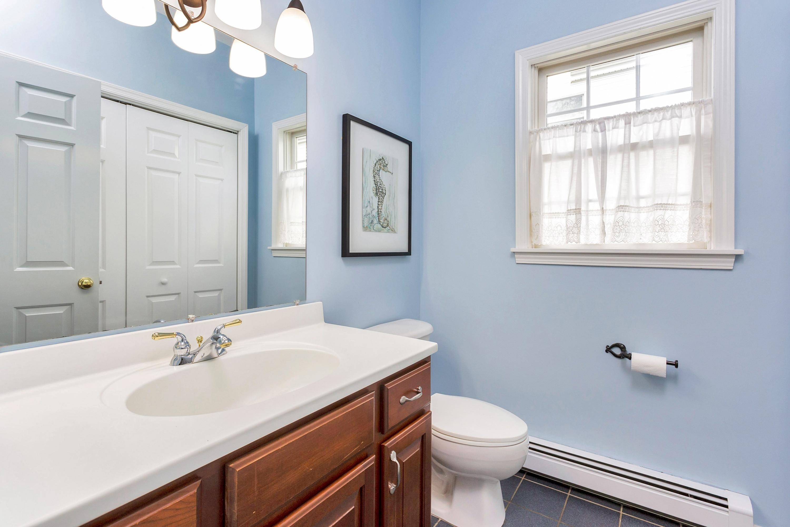 28 Dickinson Road Darien, CT 06820 - Photo 20 of 42 a bathroom with a sink a toilet and a mirror