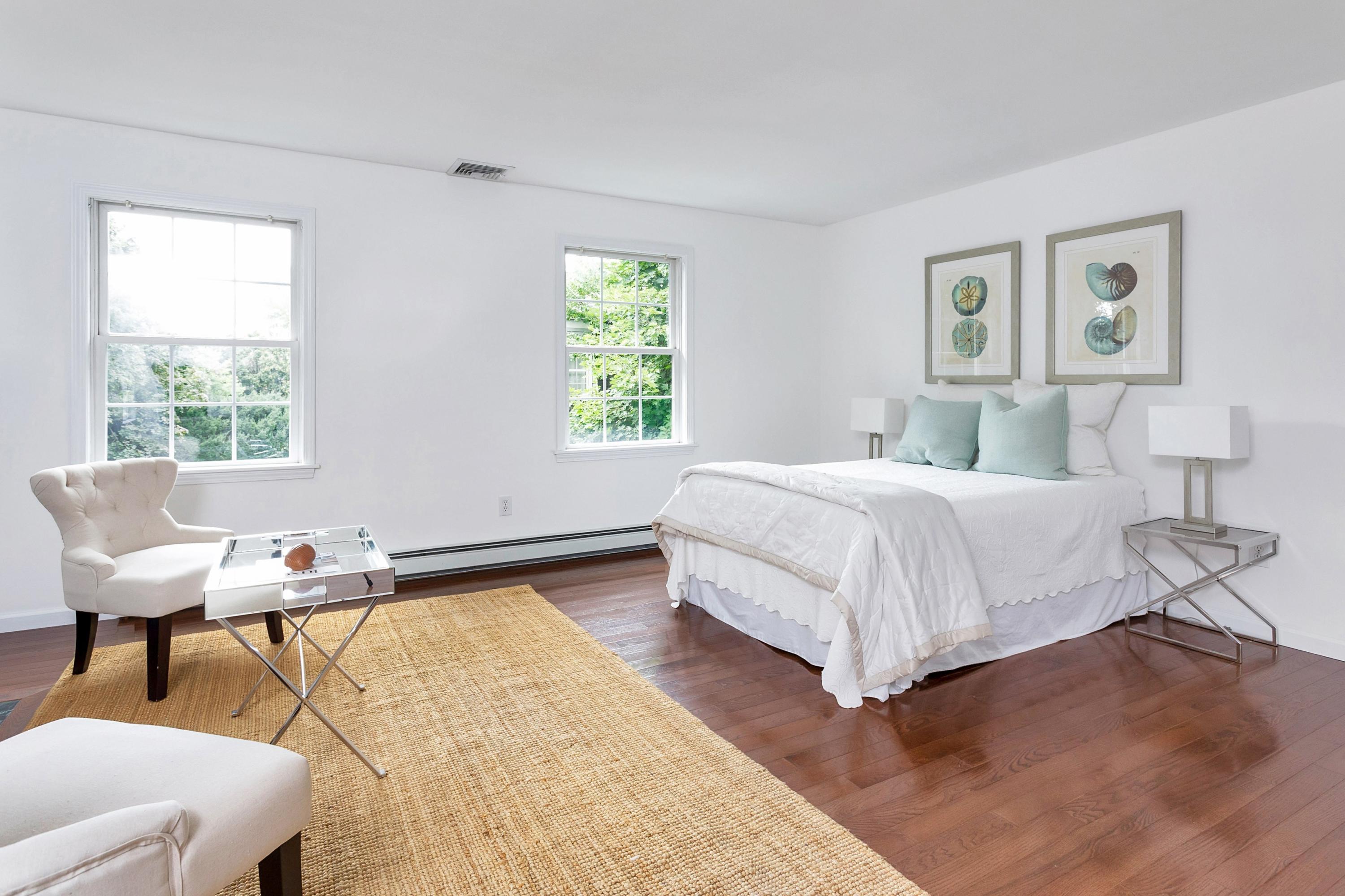 28 Dickinson Road Darien, CT 06820 - Photo 22 of 42 a bedroom with a bed and wooden floor