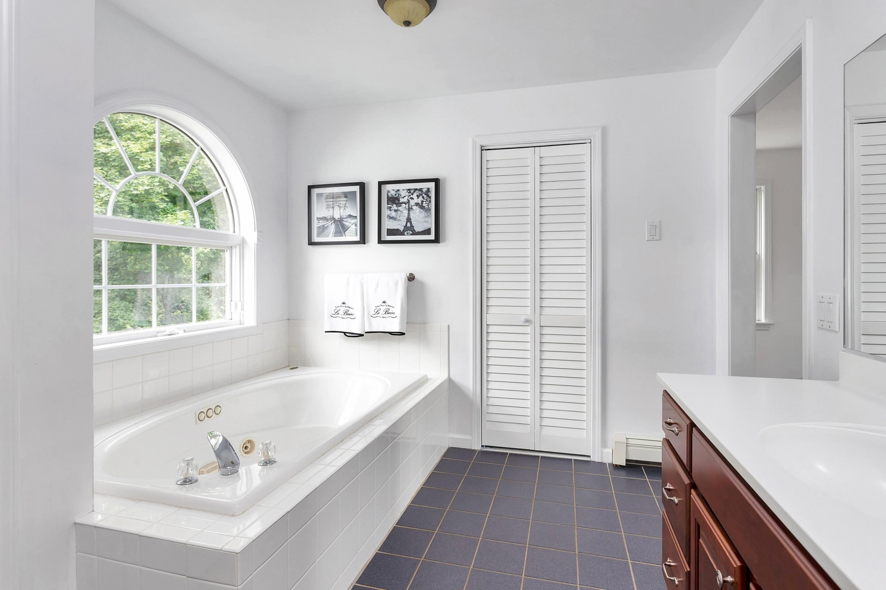 28 Dickinson Road Darien, CT 06820 - Photo 24 of 42 a bathroom with a tub a sink and a window