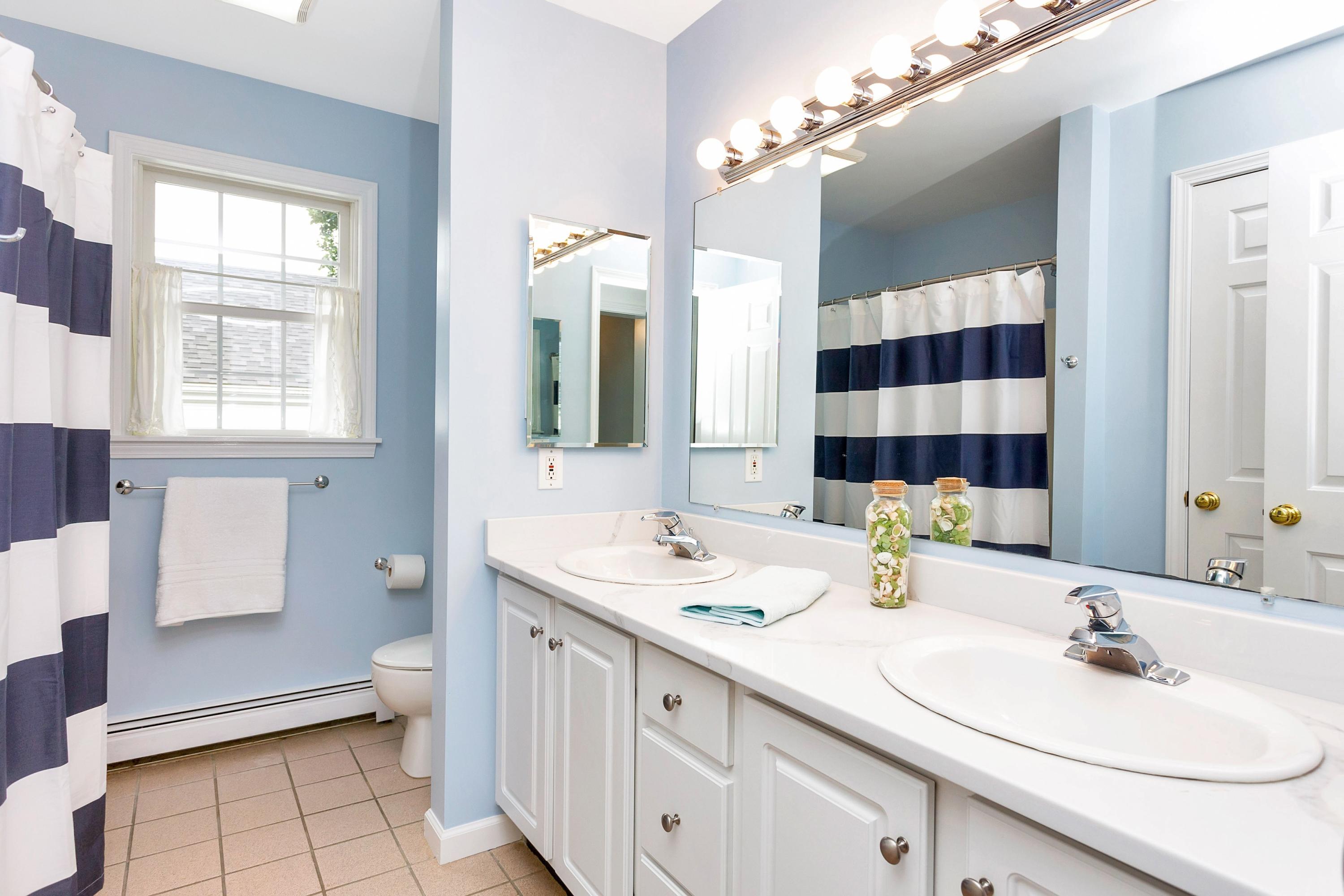 28 Dickinson Road Darien, CT 06820 - Photo 26 of 42 a bathroom with a sink double vanity and a mirror