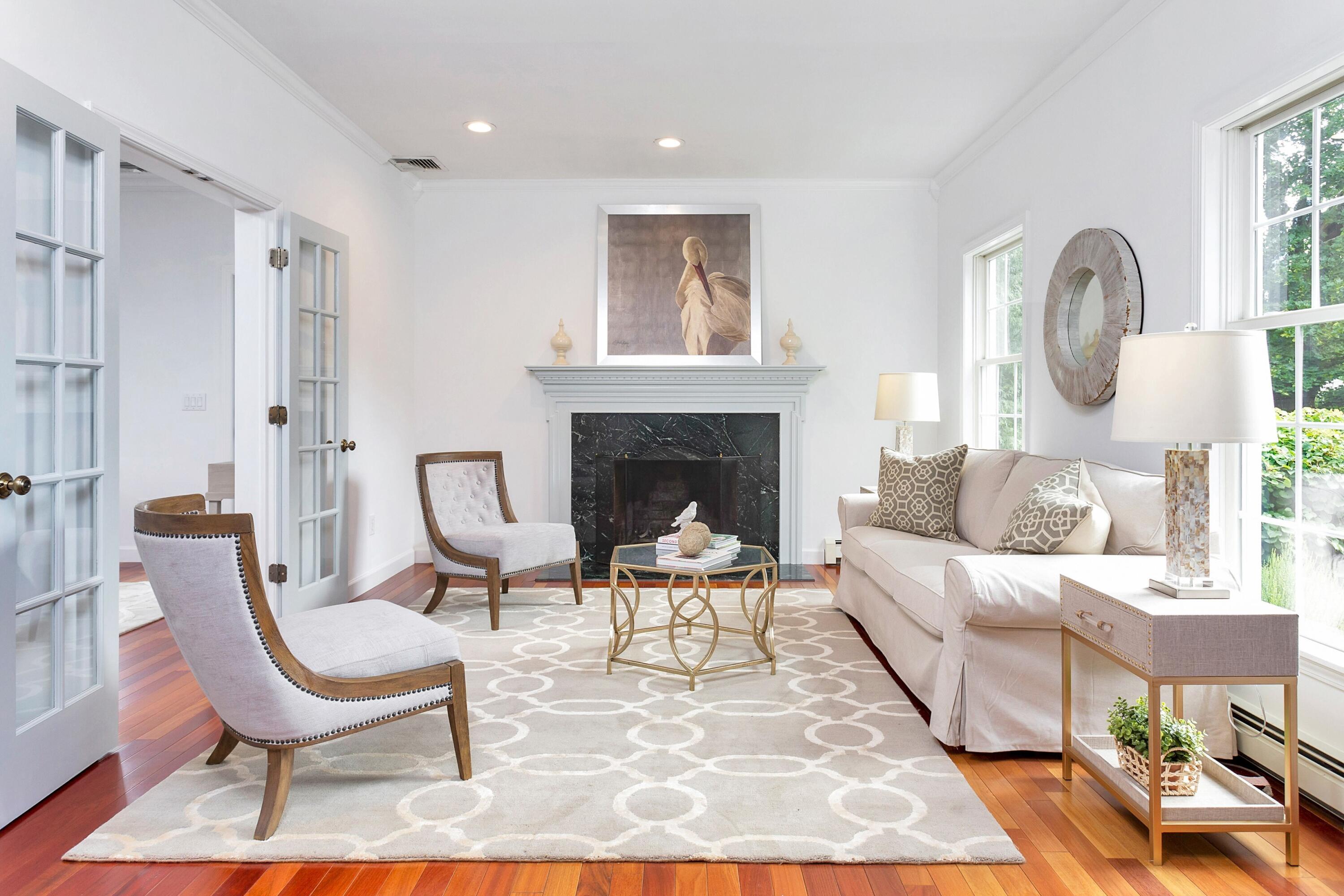 28 Dickinson Road Darien, CT 06820 - Photo 5 of 42 a living room with furniture a fireplace and a table