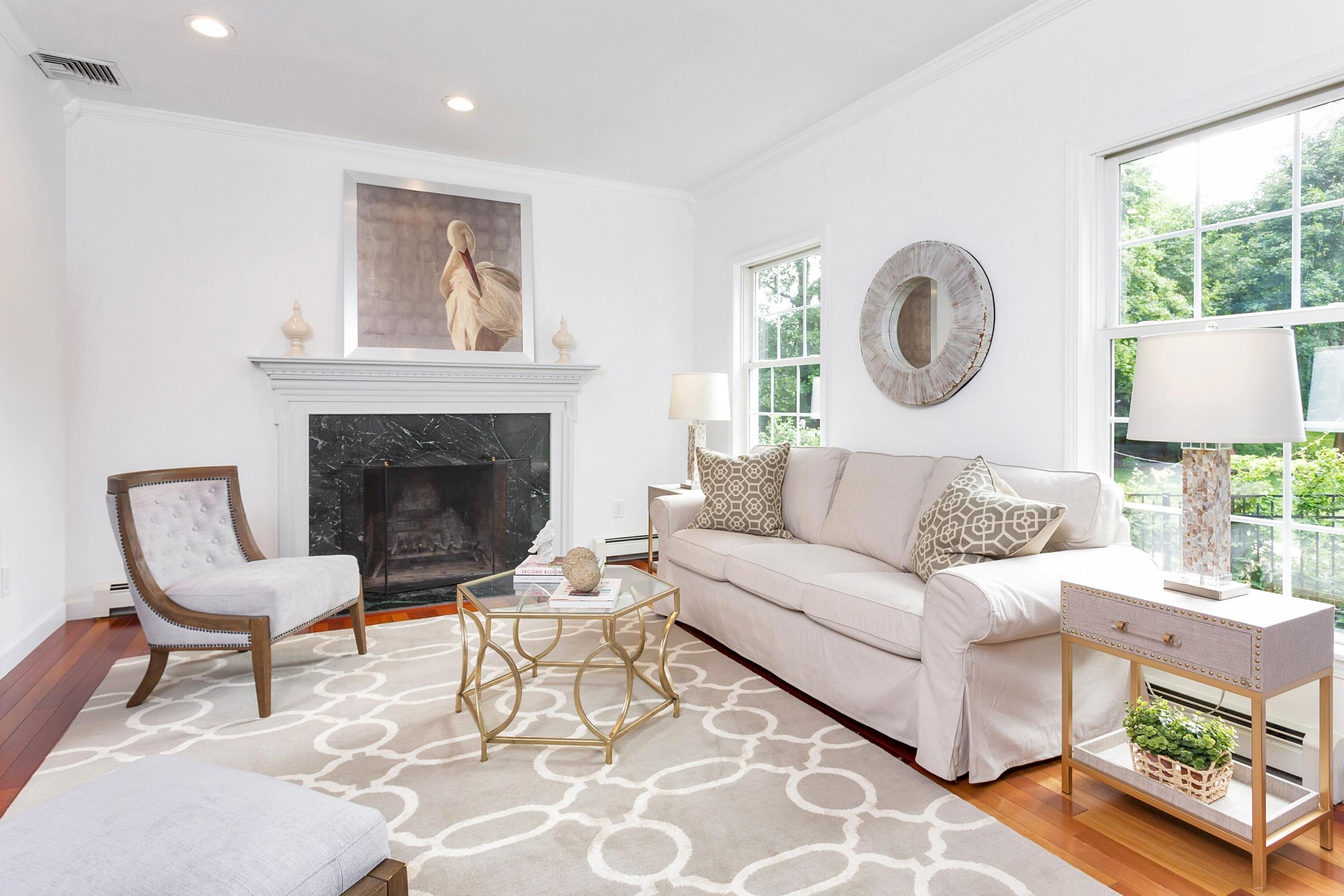 28 Dickinson Road Darien, CT 06820 - Photo 6 of 42 a living room with furniture a clock and a fireplace