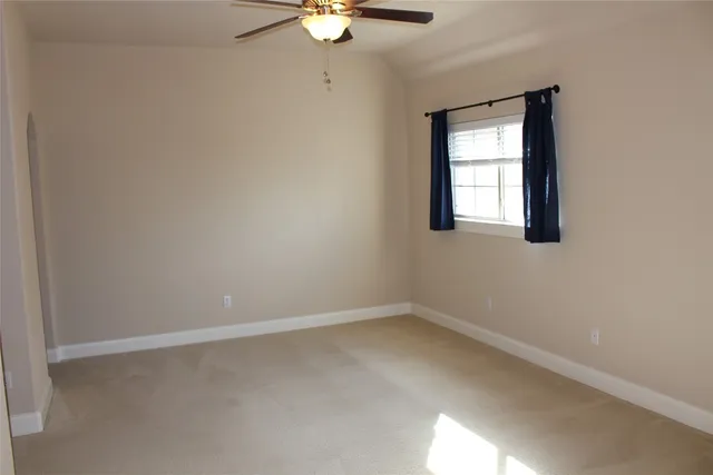 a view of an empty room with closet and wooden floor