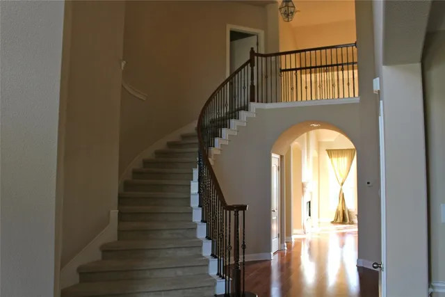 a view of staircase with wooden floor and a window