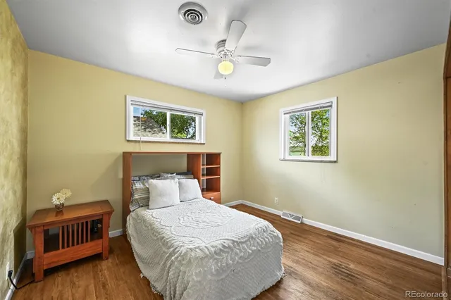a bedroom with a bed and a ceiling fan