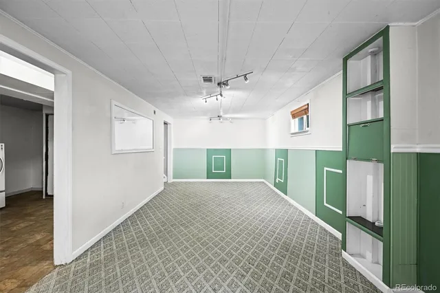 an empty room with closet and windows