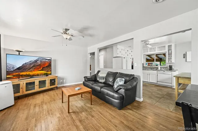 a living room with furniture kitchen view and a dining table