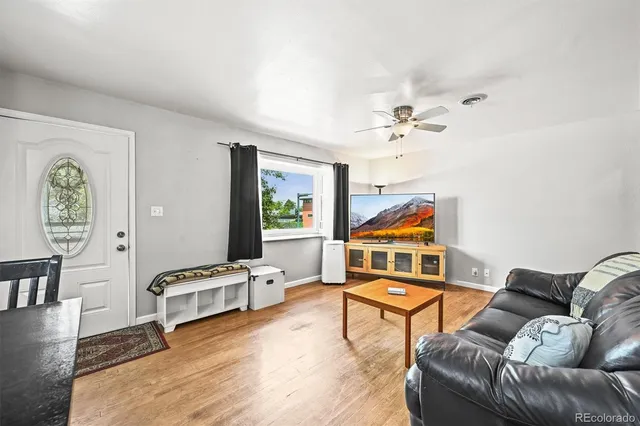 a living room with furniture tv and a window