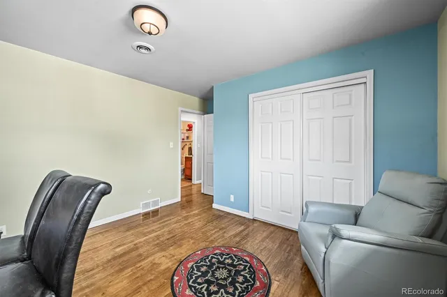 a bathroom with a granite countertop sink mirror vanity bathtub and a toilet