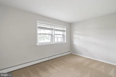 a kitchen with stainless steel appliances granite countertop a stove top oven a sink dishwasher a dining table and chairs with wooden floor