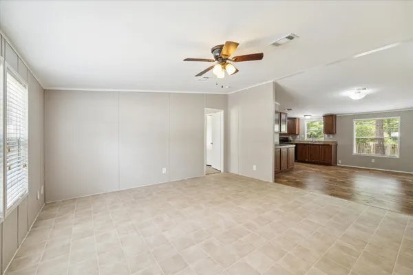 an empty room with windows and cabinet