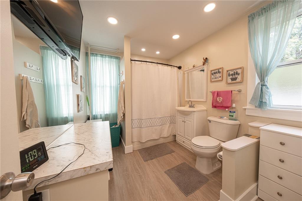 15 Old Soose Road, Unit A Pittsburgh, PA 15209 - Photo 13 of 27 a bathroom with a granite countertop sink toilet mirror vanity and shower