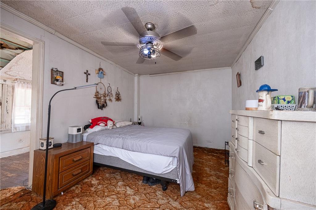 15 Old Soose Road, Unit A Pittsburgh, PA 15209 - Photo 14 of 27 a bedroom with a bed and a chandelier
