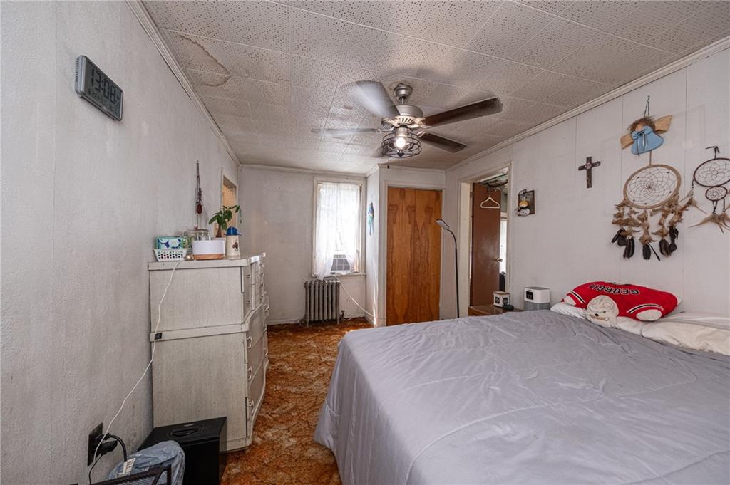 15 Old Soose Road, Unit A Pittsburgh, PA 15209 - Photo 15 of 27 a bedroom with a bed and a chandelier