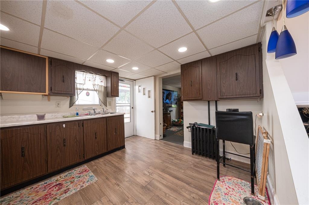 15 Old Soose Road, Unit A Pittsburgh, PA 15209 - Photo 8 of 27 a kitchen with refrigerator cabinets and wooden floor