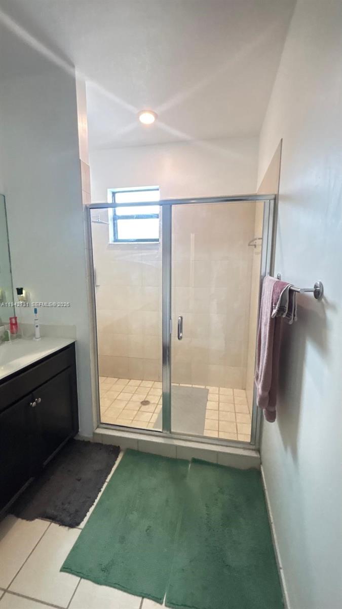 25380 Southwest 115th Court Homestead, FL 33032 - Photo 17 of 32 a bathroom with a glass shower door and a bathtub
