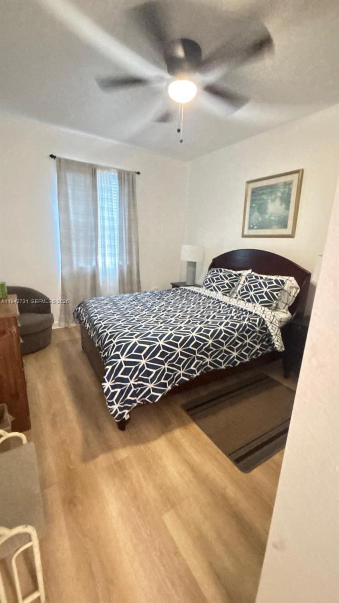 25380 Southwest 115th Court Homestead, FL 33032 - Photo 18 of 32 a bedroom with a bed and a painting on the wall