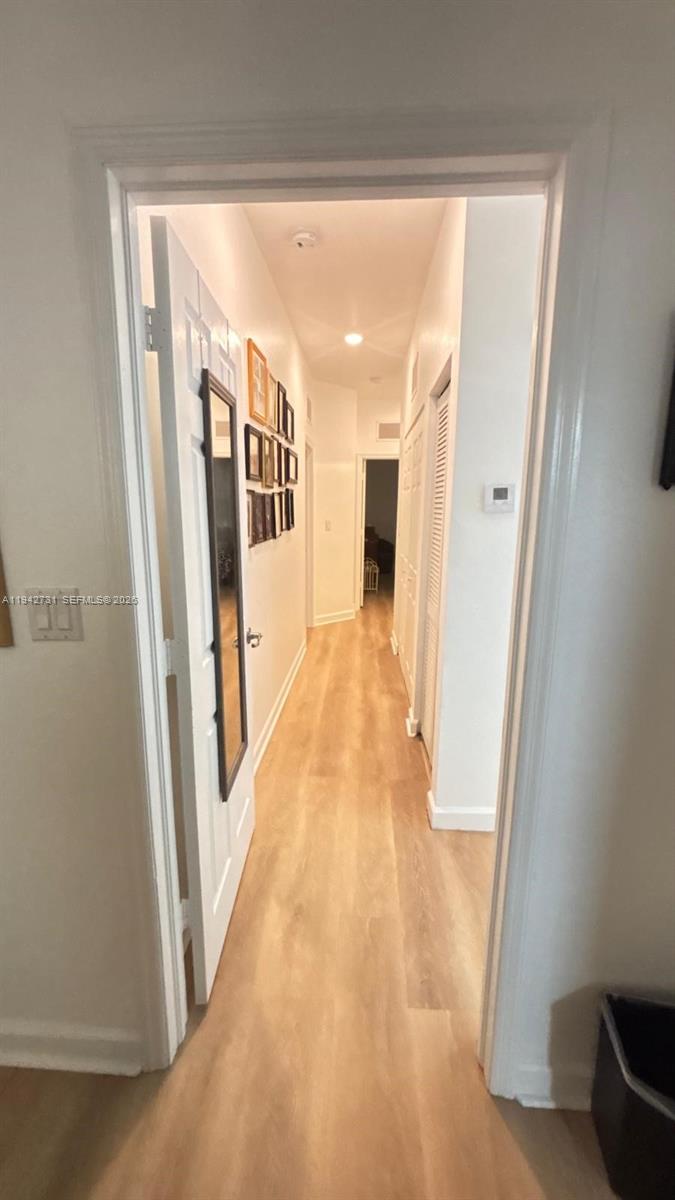 25380 Southwest 115th Court Homestead, FL 33032 - Photo 19 of 32 a view of a hallway with wooden floor and staircase