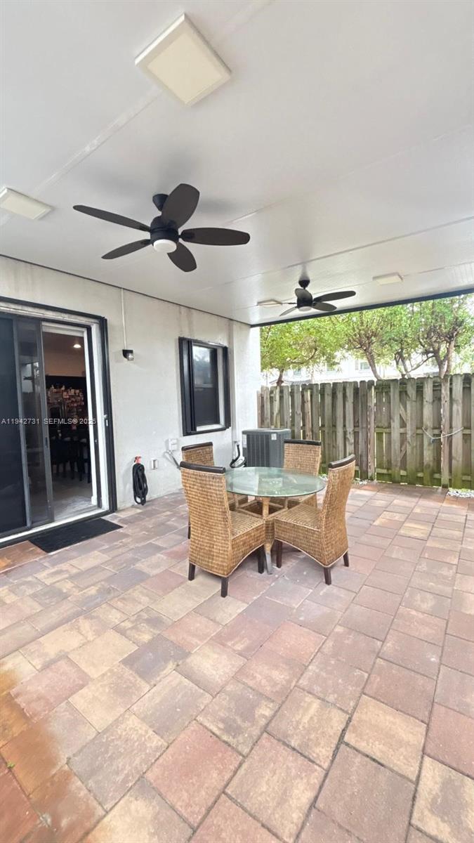 25380 Southwest 115th Court Homestead, FL 33032 - Photo 24 of 32 a living room with patio furniture and a fireplace