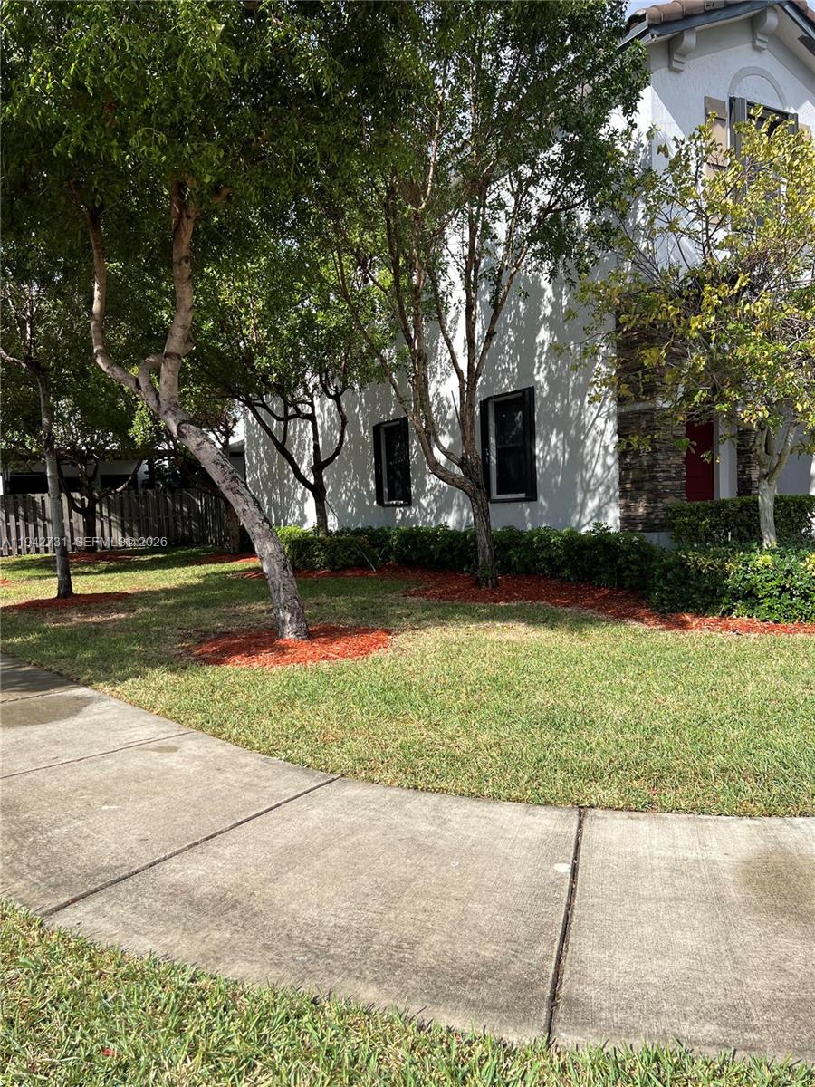 25380 Southwest 115th Court Homestead, FL 33032 - Photo 29 of 32 a view of a yard with plants and trees
