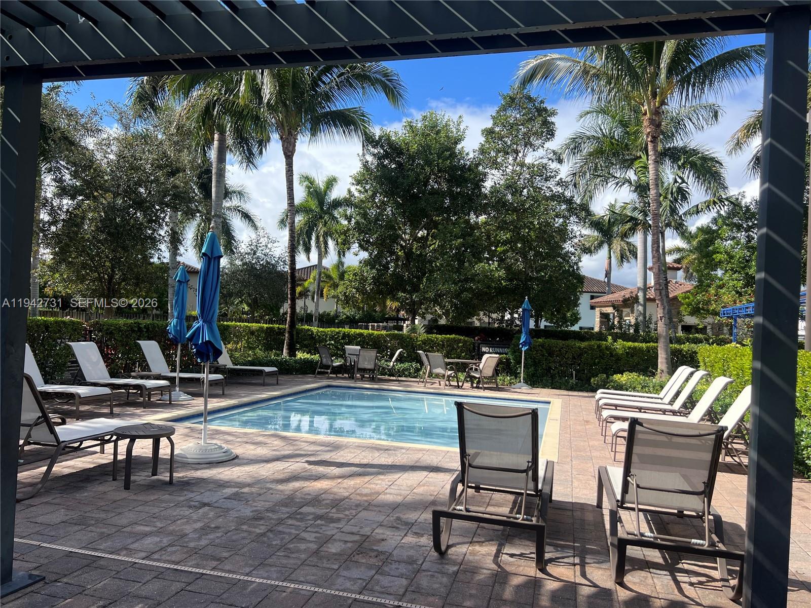 25380 Southwest 115th Court Homestead, FL 33032 - Photo 31 of 32 a view of a chairs and fire pit in the patio