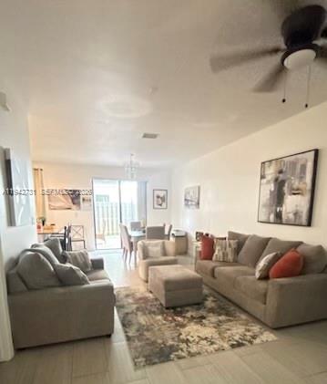 25380 Southwest 115th Court Homestead, FL 33032 - Photo 6 of 32 a living room with furniture and a large window