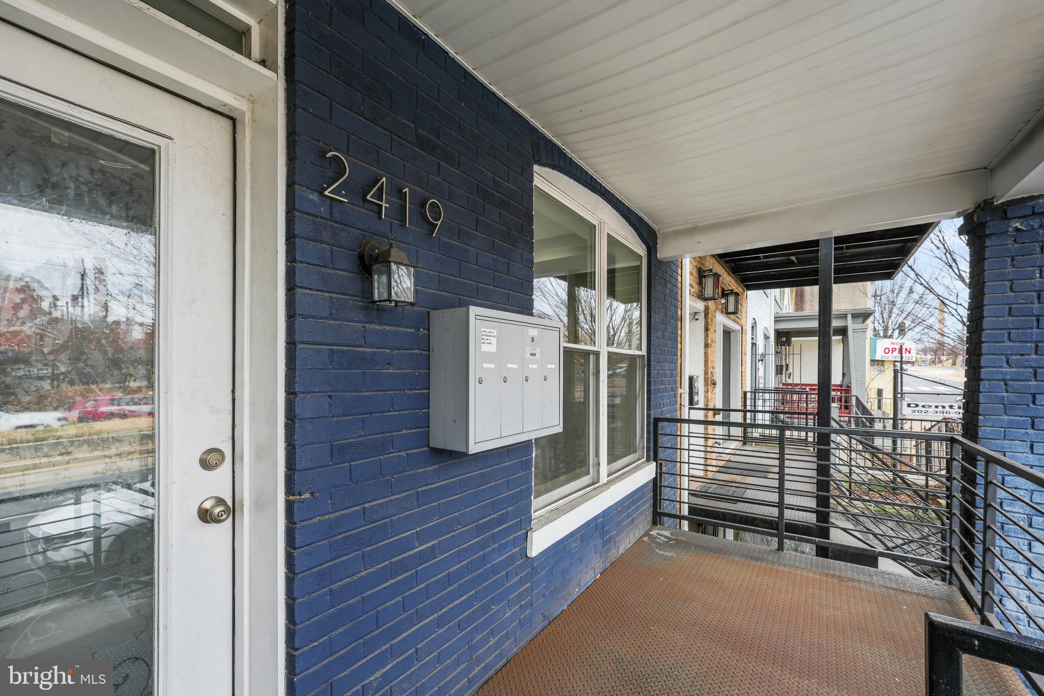 a view of front door and porch with wooden floor