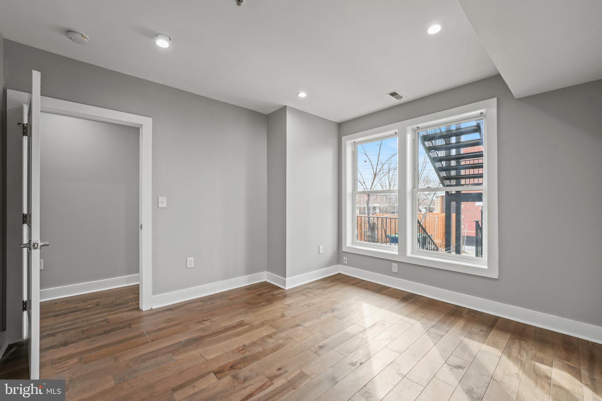 2419 Benning Road Northeast Washington, DC 20002 - Photo 12 of 22 a view of an empty room with wooden floor and a window