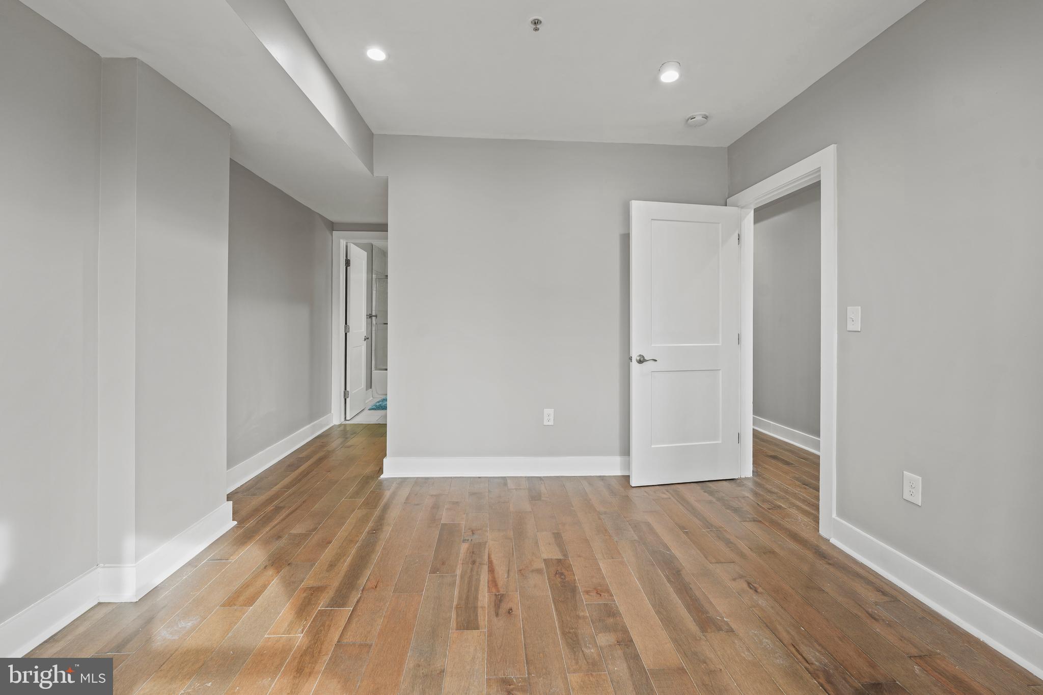 2419 Benning Road Northeast Washington, DC 20002 - Photo 13 of 22 wooden floor in an empty room with a window