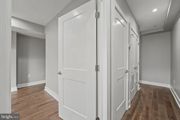 a view of a hallway with wooden floor