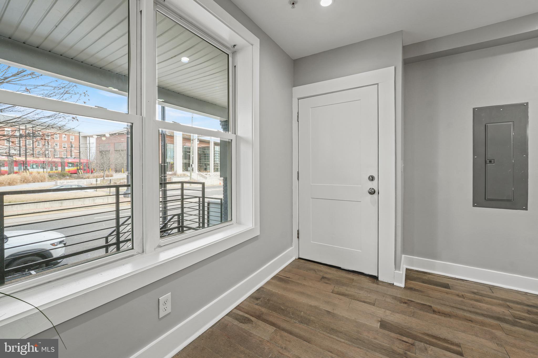 2419 Benning Road Northeast Washington, DC 20002 - Photo 19 of 22 a view of an empty room with wooden floor and a window
