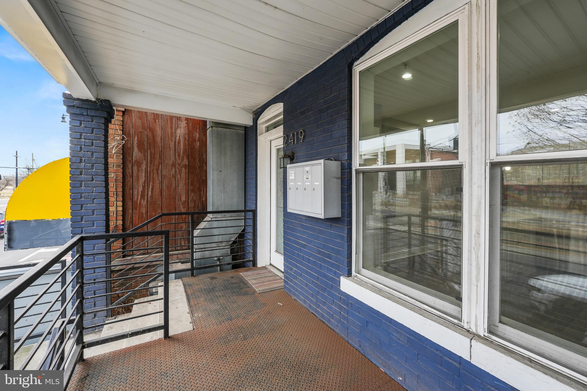 2419 Benning Road Northeast Washington, DC 20002 - Photo 3 of 22 a view of a hallway with wooden floor and glass door