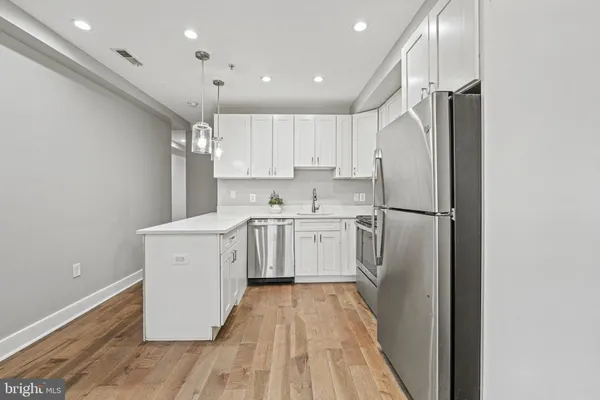 a kitchen with a refrigerator a sink and dishwasher