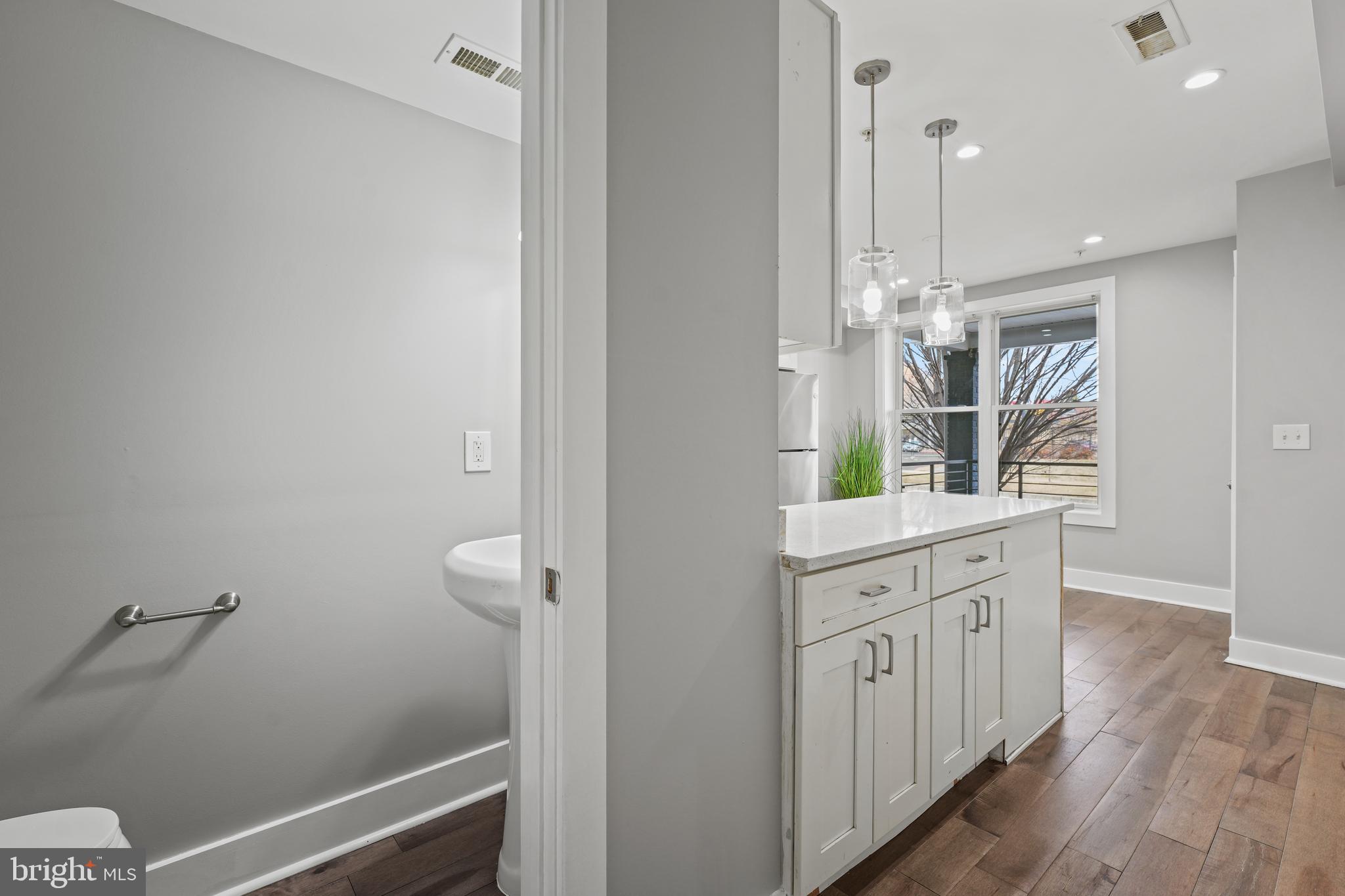 2419 Benning Road Northeast Washington, DC 20002 - Photo 7 of 22 a spacious bathroom with a double vanity sink and a mirror