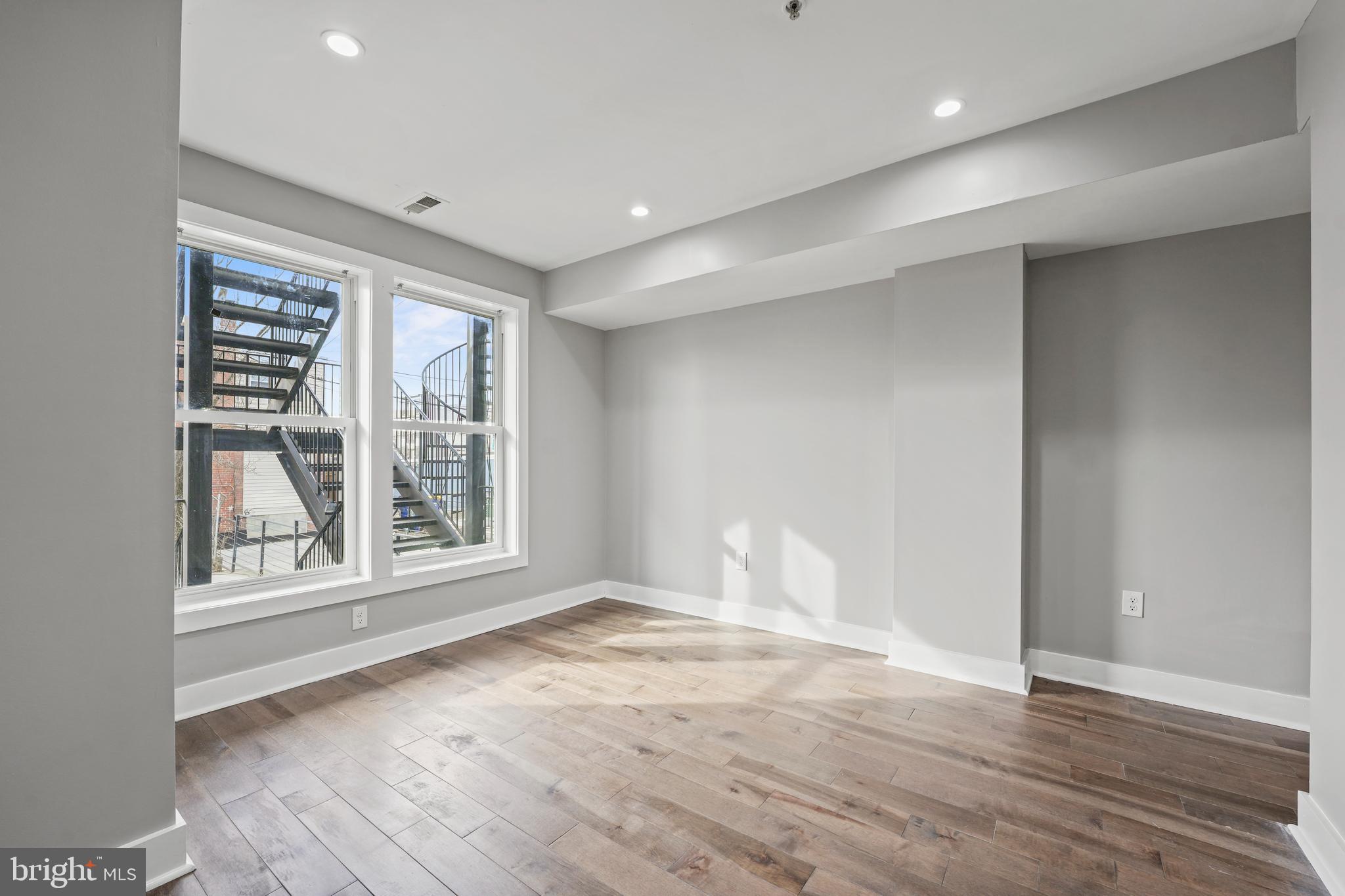 2419 Benning Road Northeast Washington, DC 20002 - Photo 10 of 22 wooden floor in an empty room with a window