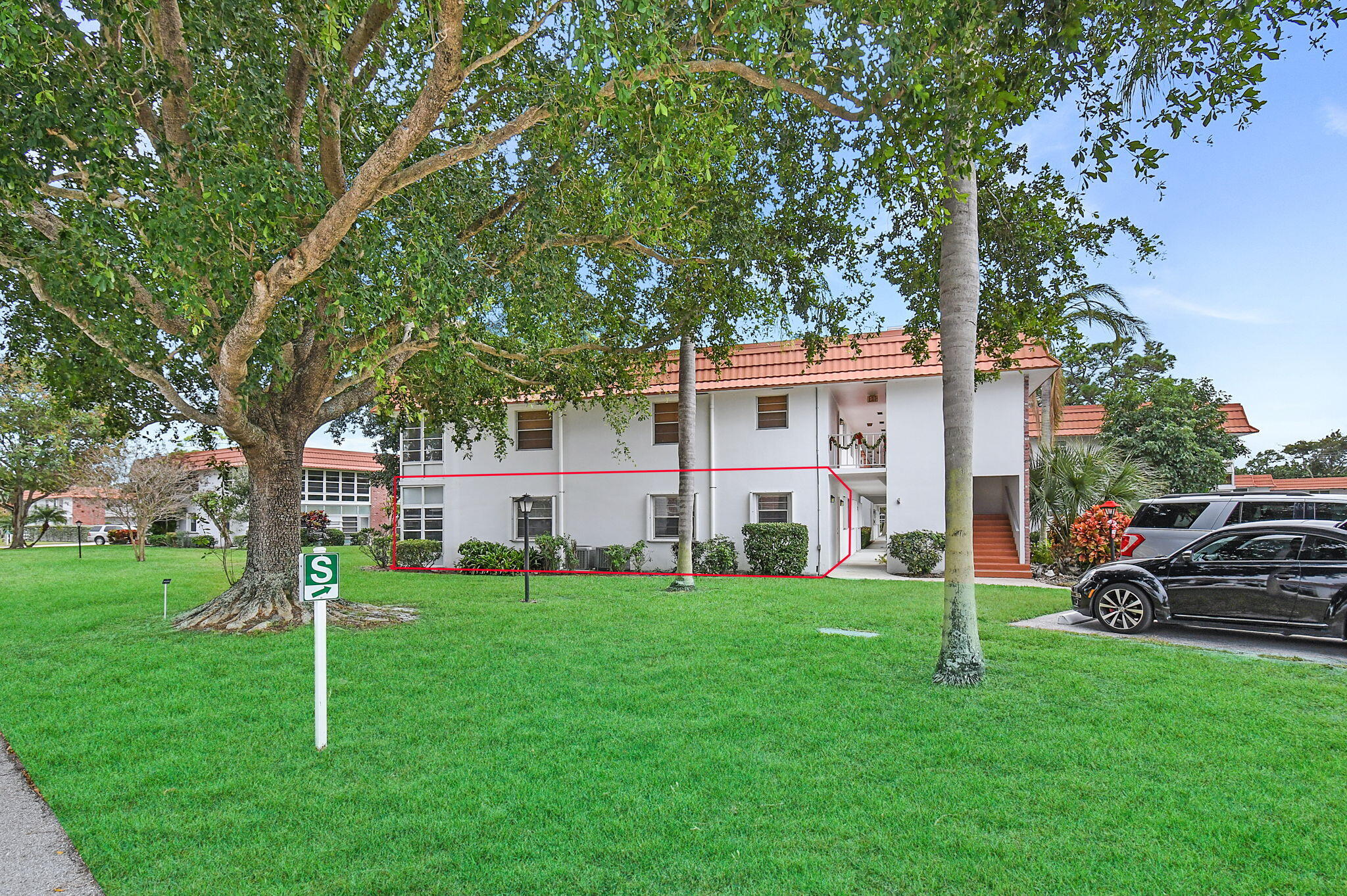 a view of a house with a yard and sitting area