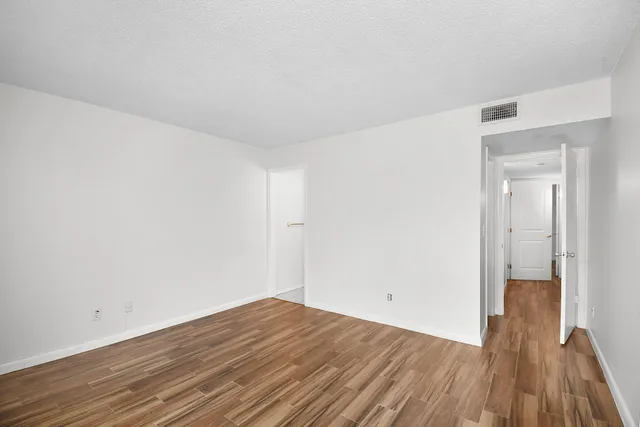 a view of a room with wooden floor