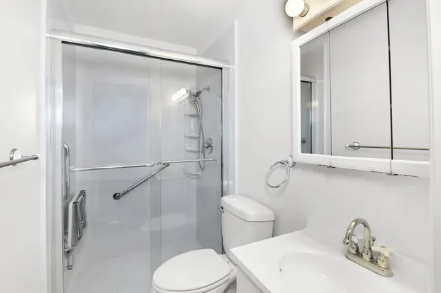 a bathroom with a toilet sink and shower