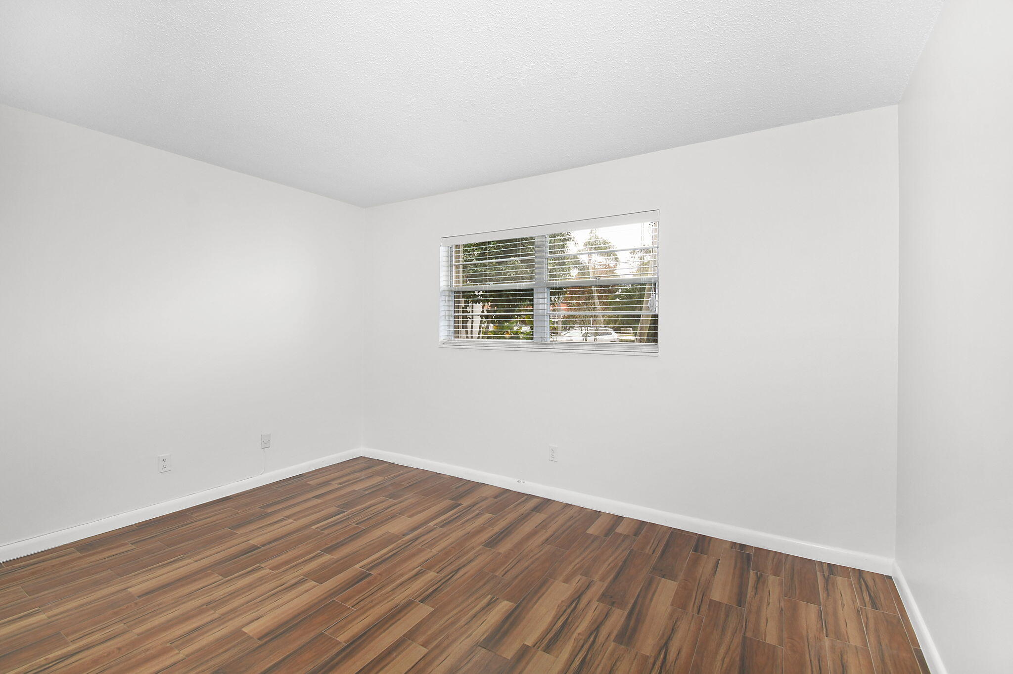 2600 Southeast Ocean Boulevard, Unit S7 Stuart, FL 34996 - Photo 16 of 38 an empty room with wooden floor and windows