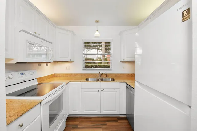 a kitchen with a sink cabinets and window