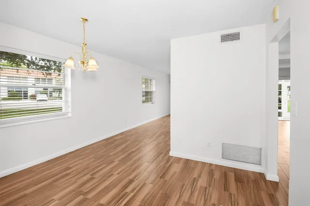 a view of a room with wooden floor and window