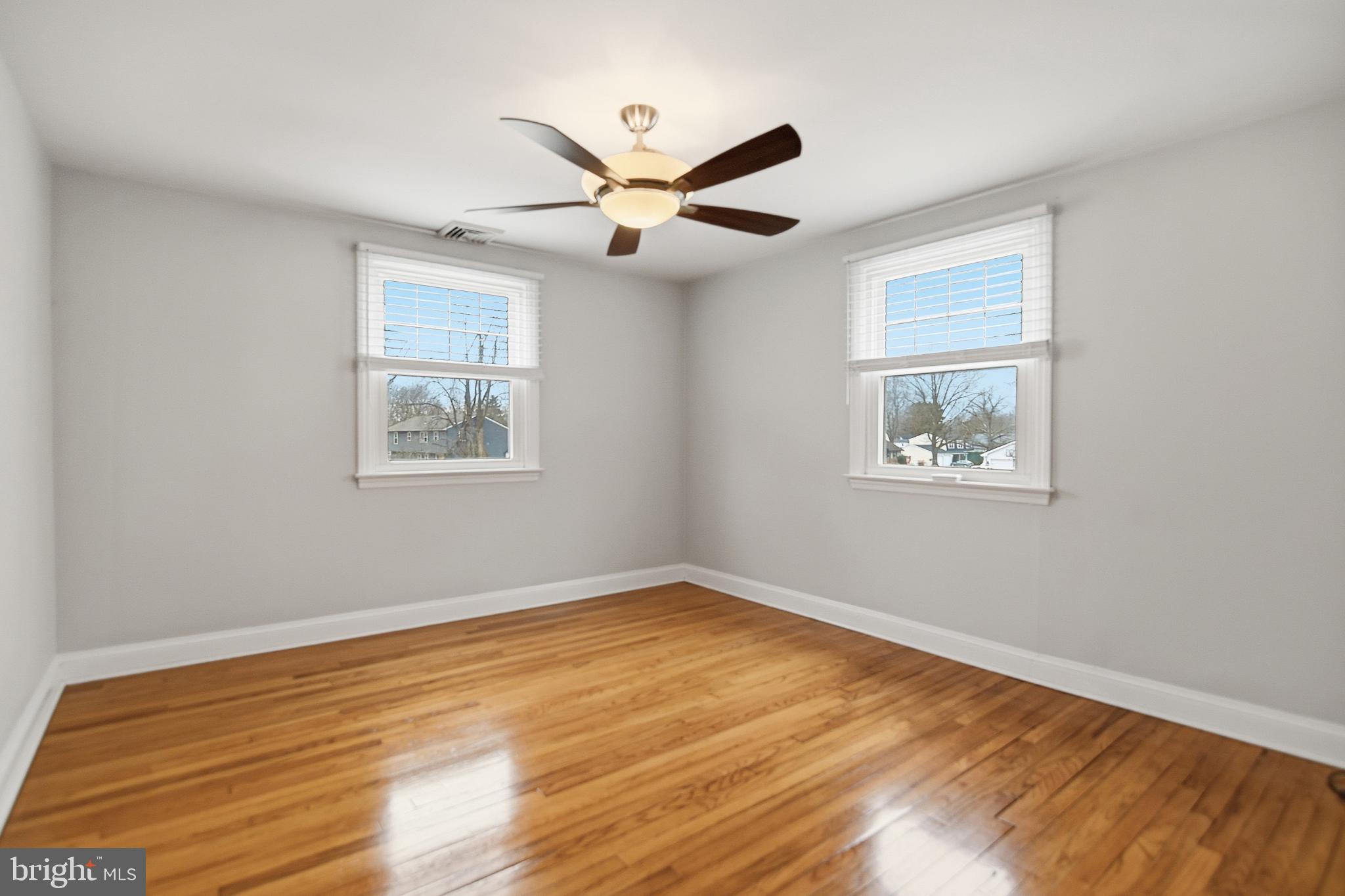 40 Lee Street, Unit B Woodstown, NJ 08098 - Photo 12 of 21 a view of an empty room with wooden floor and a ceiling fan