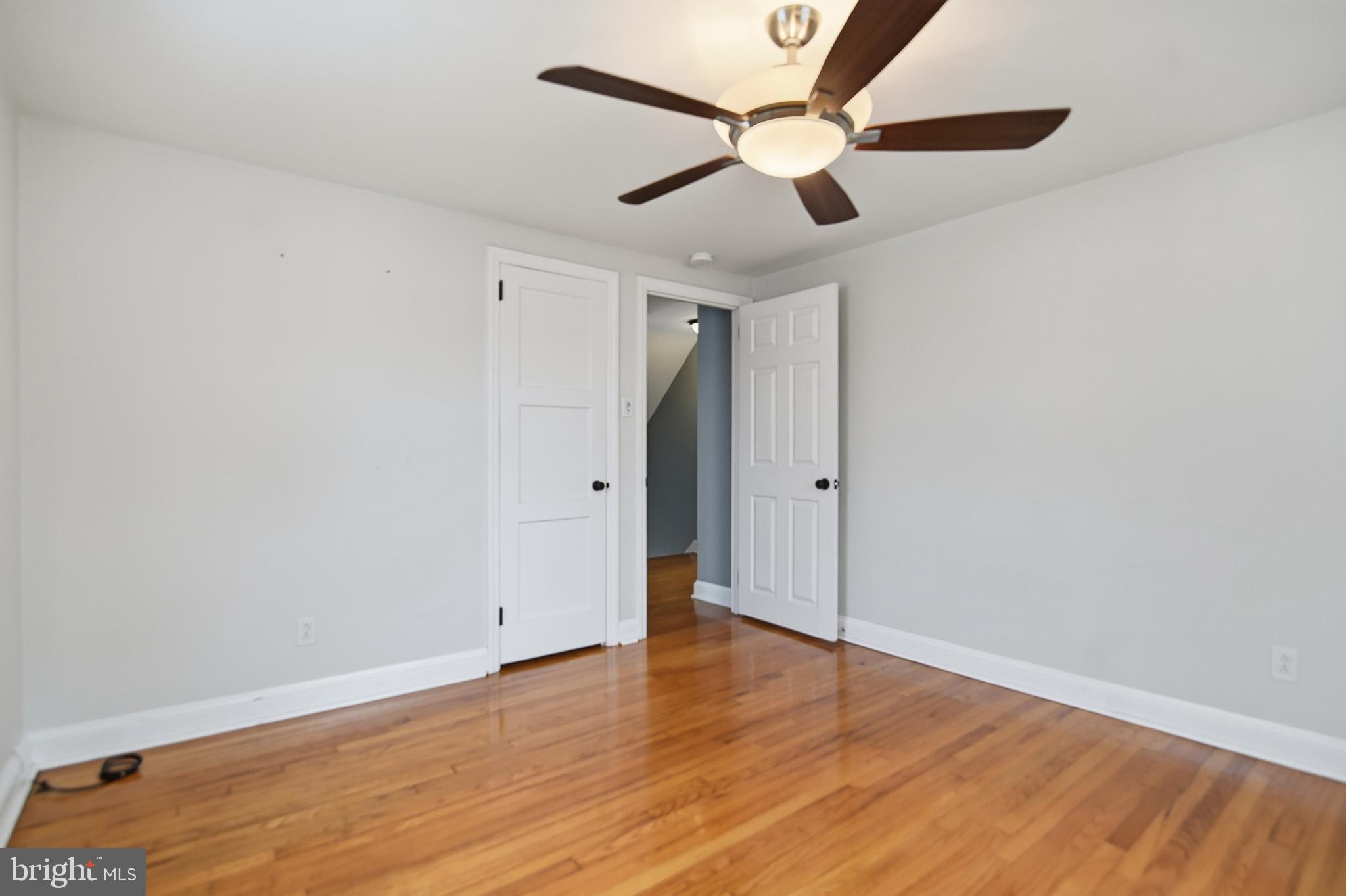 40 Lee Street, Unit B Woodstown, NJ 08098 - Photo 13 of 21 an empty room with wooden floor ceiling fan and window