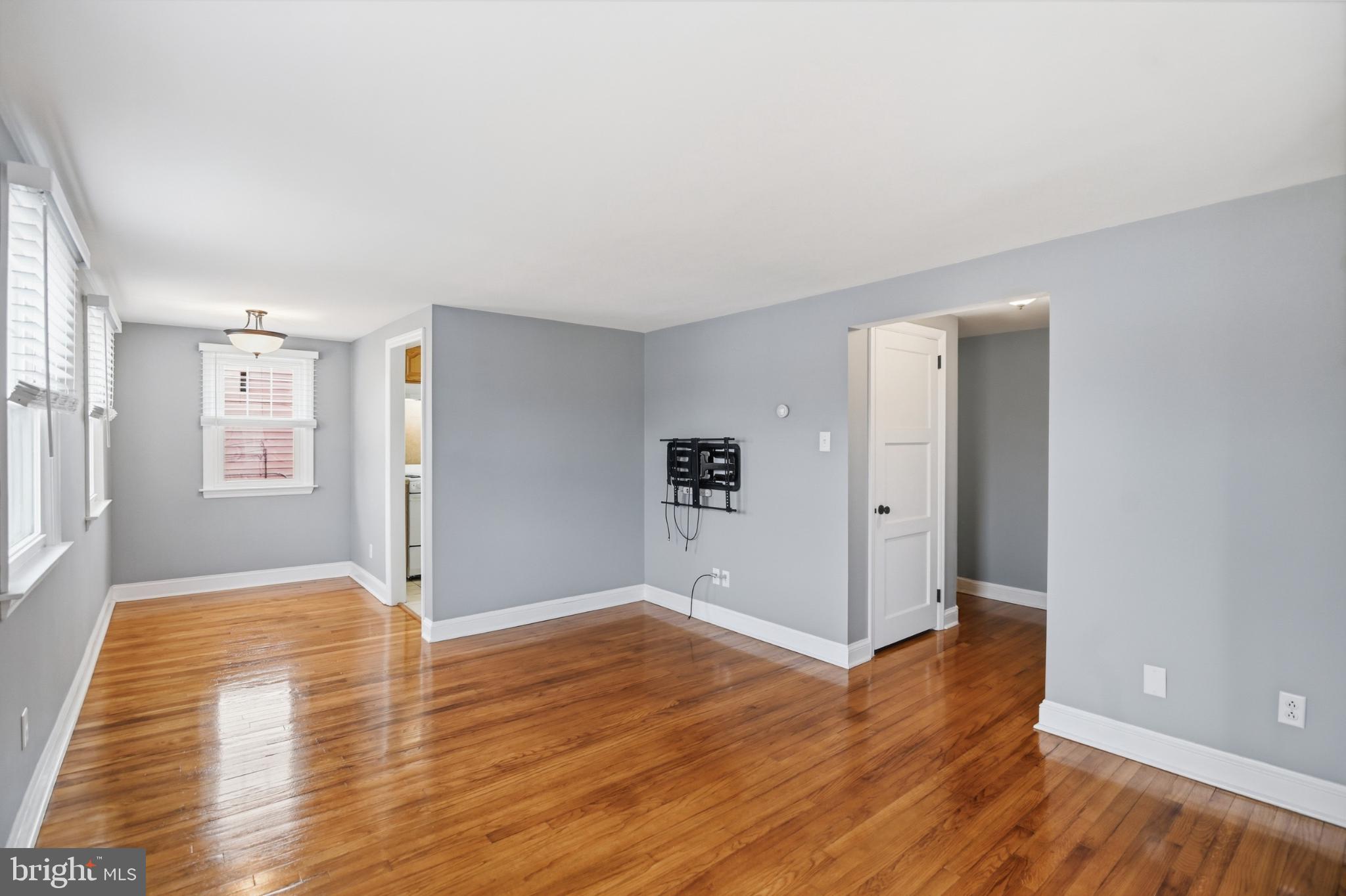 40 Lee Street, Unit B Woodstown, NJ 08098 - Photo 7 of 21 wooden floor in an empty room with a window