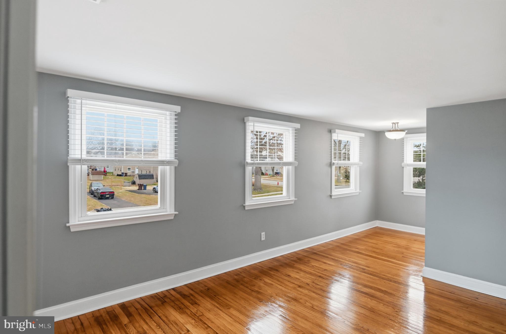 40 Lee Street, Unit B Woodstown, NJ 08098 - Photo 8 of 21 a view of an empty room with wooden floor and a window