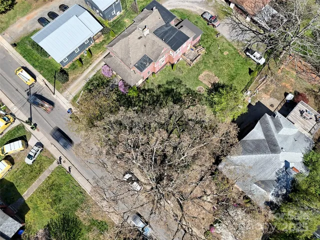 an aerial view of a house with a yard and lake view