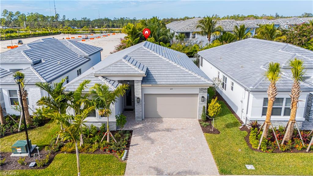 2691 Ridgecrest Place Naples, FL 34112 - Photo 2 of 27 a view of a house with a yard and sitting area